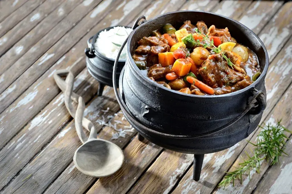 Potjiekos, a South African stew cooked in a three legged cast iron pot over an open fire